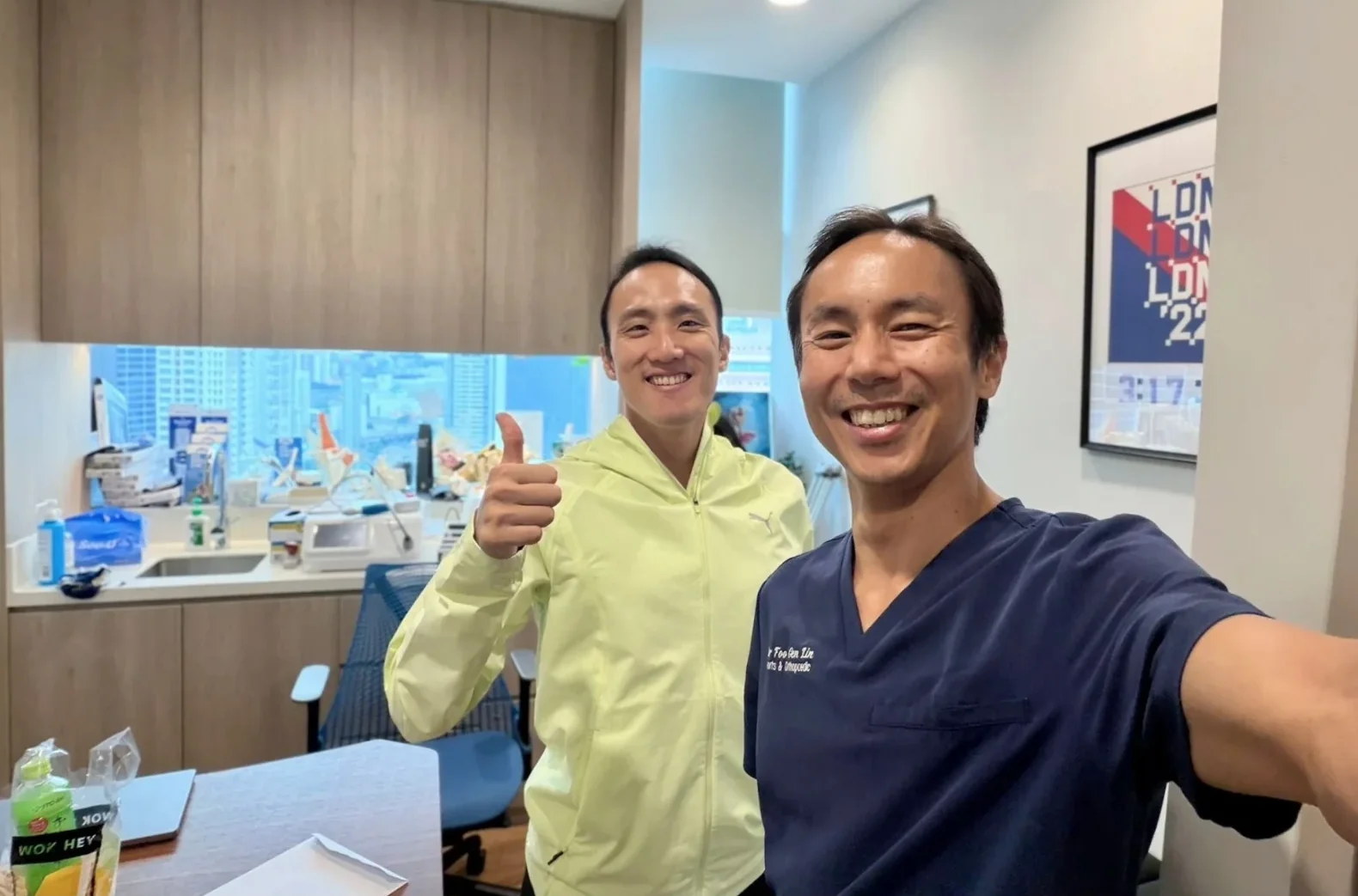 Dr Foo Gen Lin with a patient at Apex Sports Clinic, a sports doctor clinic in Singapore